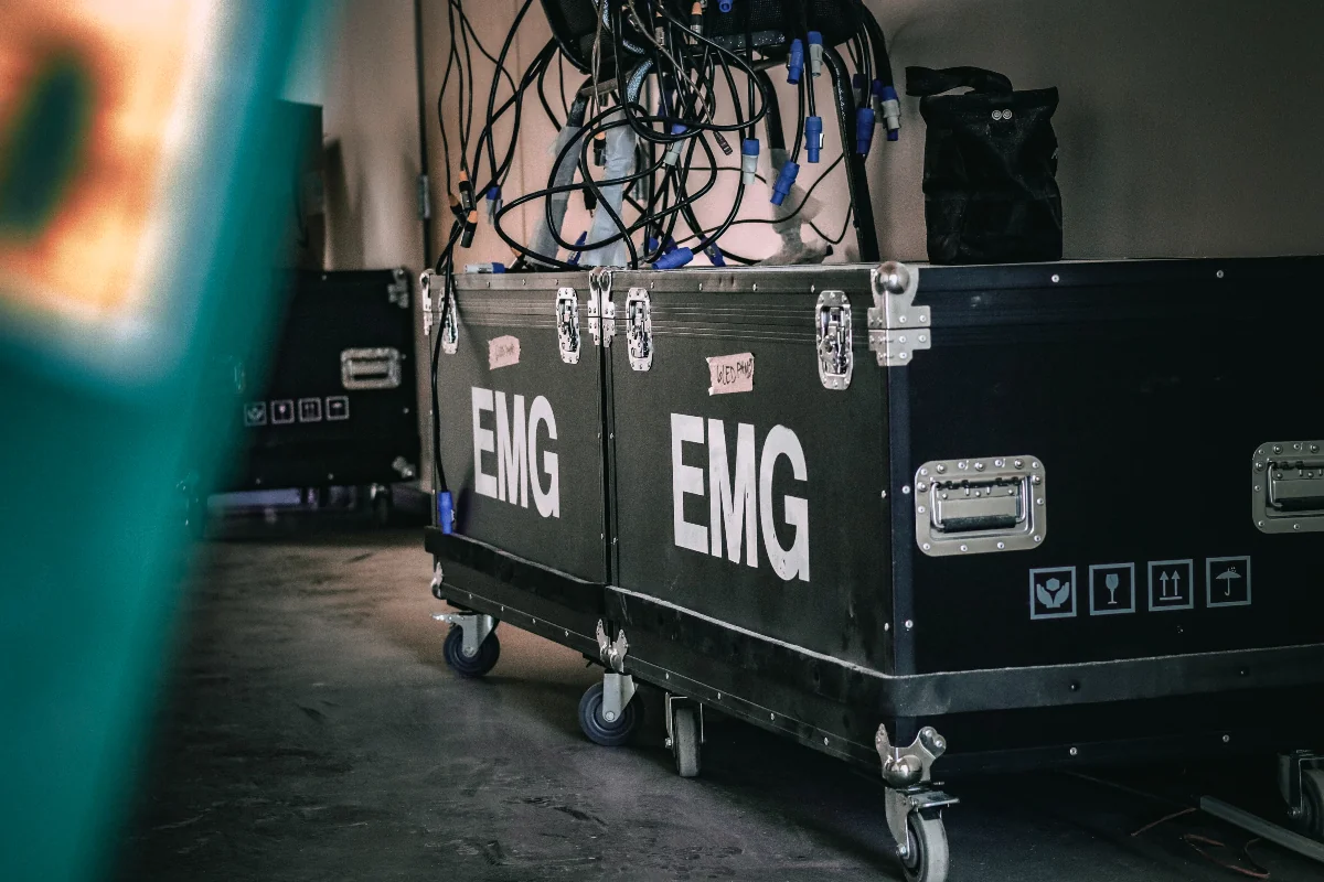 EMG branded road cases and production gear staged for load in