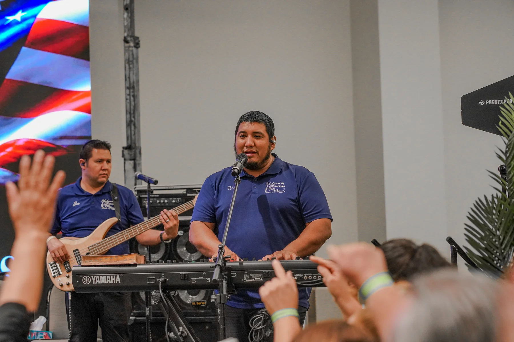 Band performing with microphones, speakers and stage equipment